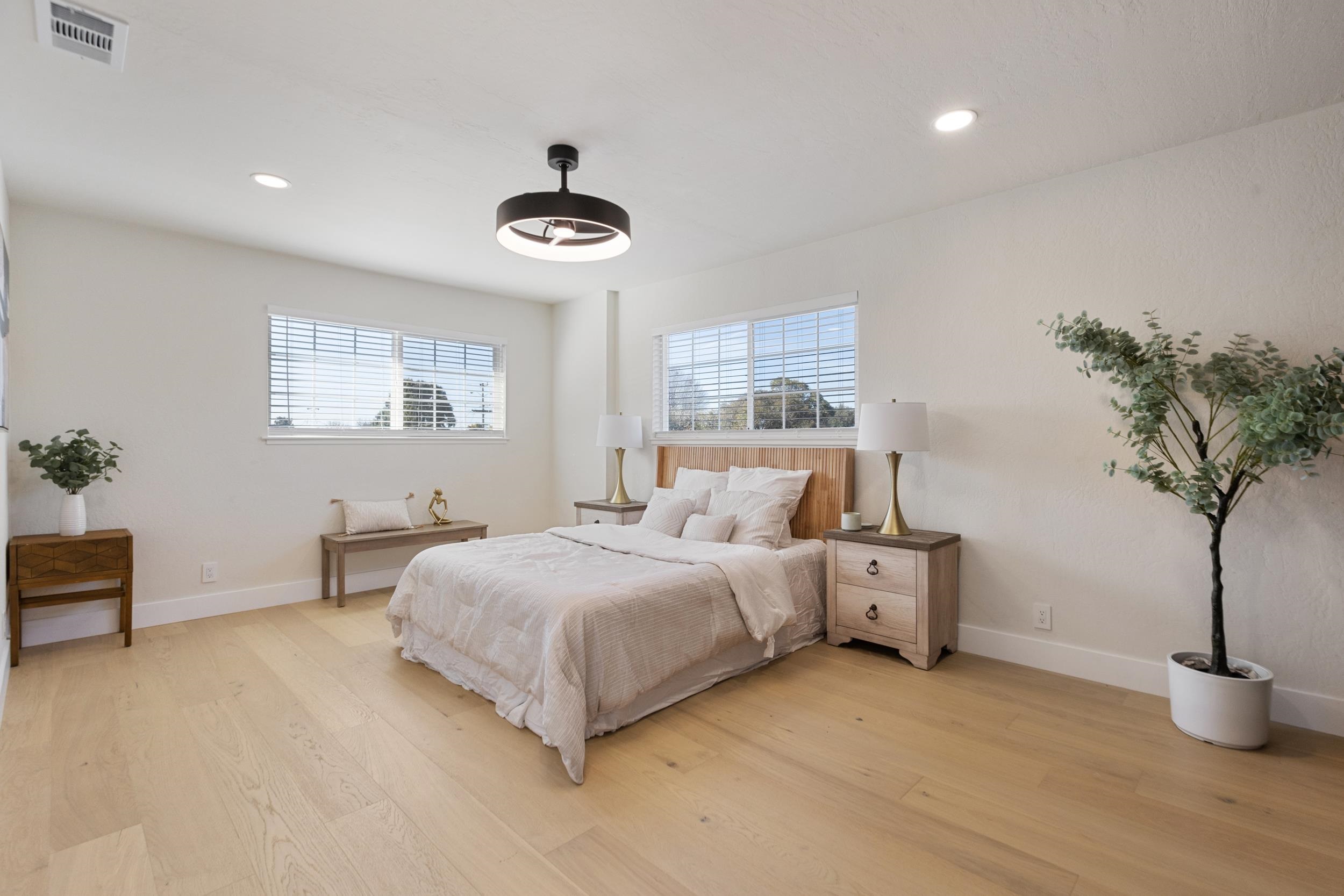 38952 Emrol Avenue Fremont, CA 94536 - Photo 39 of 59 a spacious bedroom with a bed and a potted plant