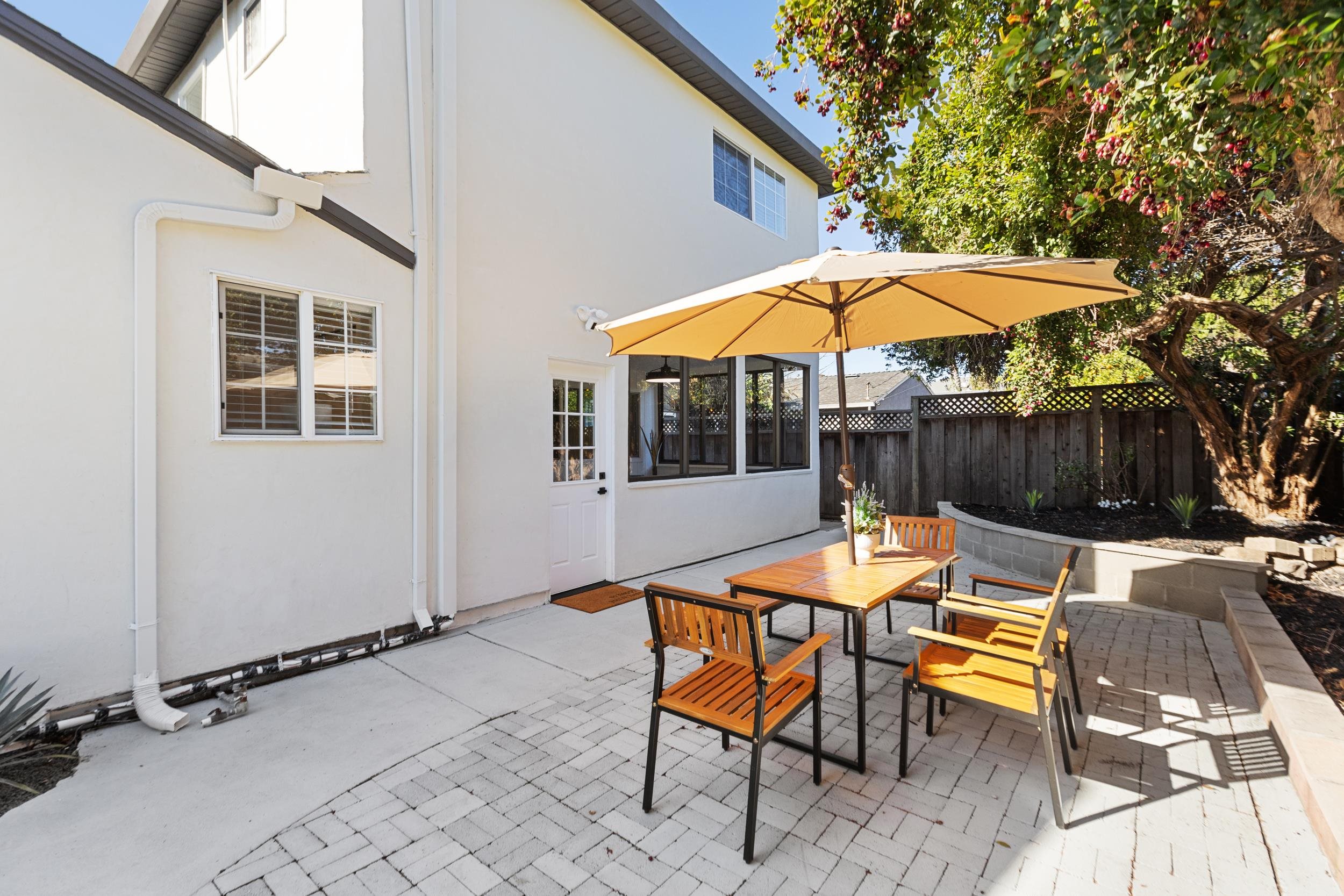 38952 Emrol Avenue Fremont, CA 94536 - Photo 48 of 59 a view of a patio with a table and chairs under an umbrella