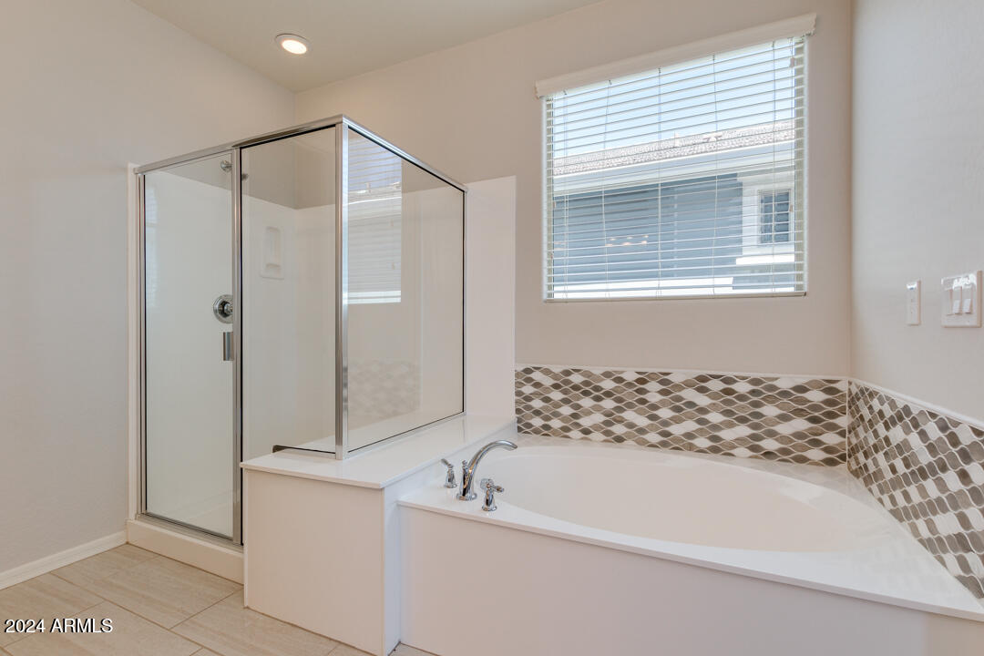 3661 East STILES Lane Gilbert, AZ 85295 - Photo 20 of 38 a bathroom with a bathtub and a shower