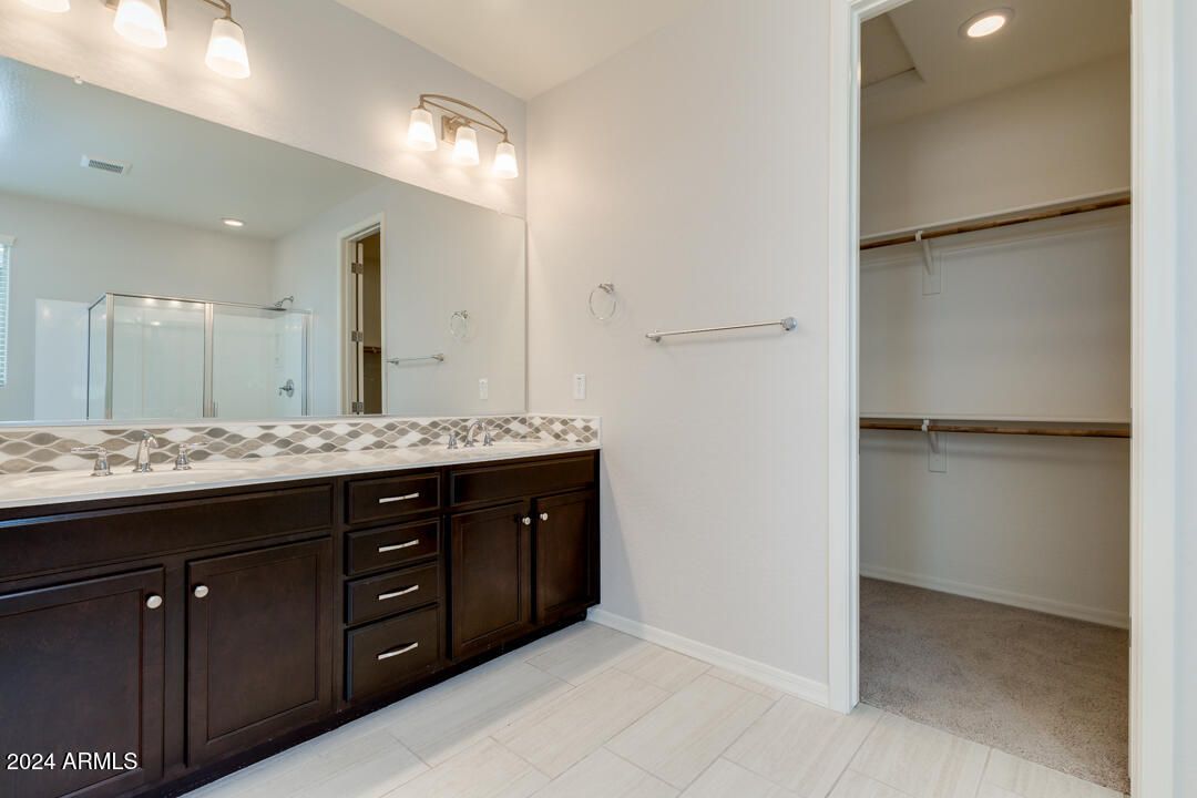 3661 East STILES Lane Gilbert, AZ 85295 - Photo 21 of 38 a bathroom with a granite countertop sink and a mirror