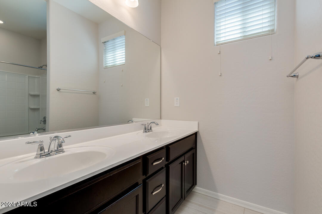 3661 East STILES Lane Gilbert, AZ 85295 - Photo 27 of 38 a bathroom with a double vanity sink and a mirror