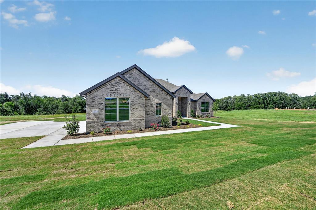 409 Mcalpine Springtown, TX 76082 - Photo 3 of 38 Brick exterior with dark gray roofing