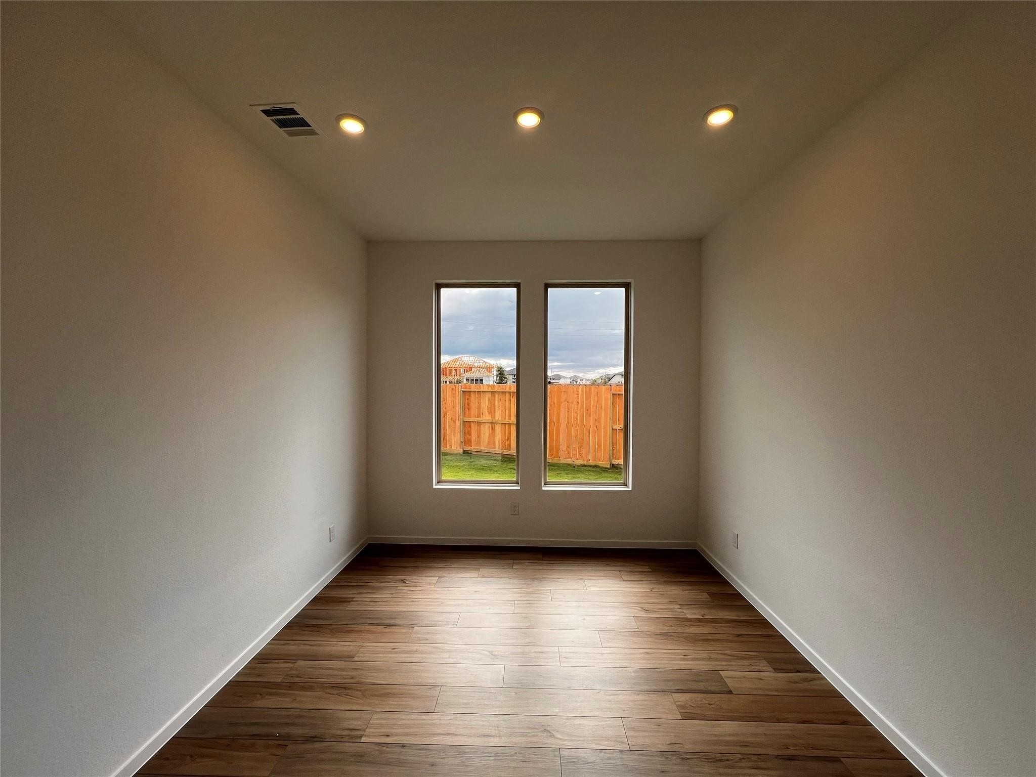 31119 Riley Hts Drive Fulshear, TX 77441 - Photo 14 of 34 an empty room with wooden floor and windows