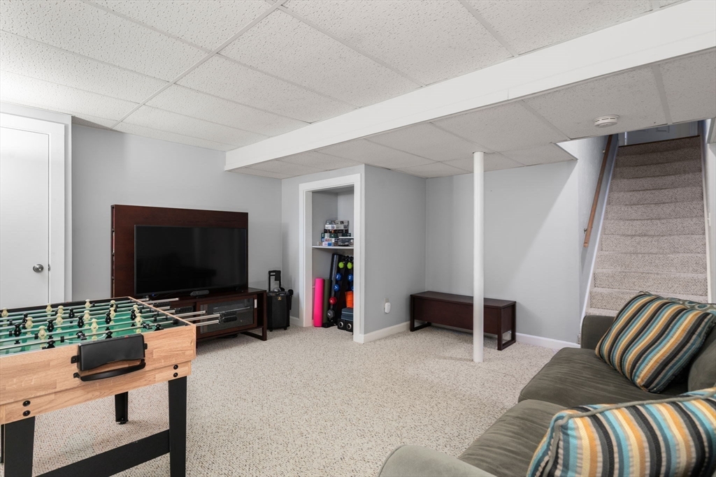 33 Upwey Road Wellesley, MA 02481 - Photo 29 of 34 a bedroom with furniture and a flat screen tv