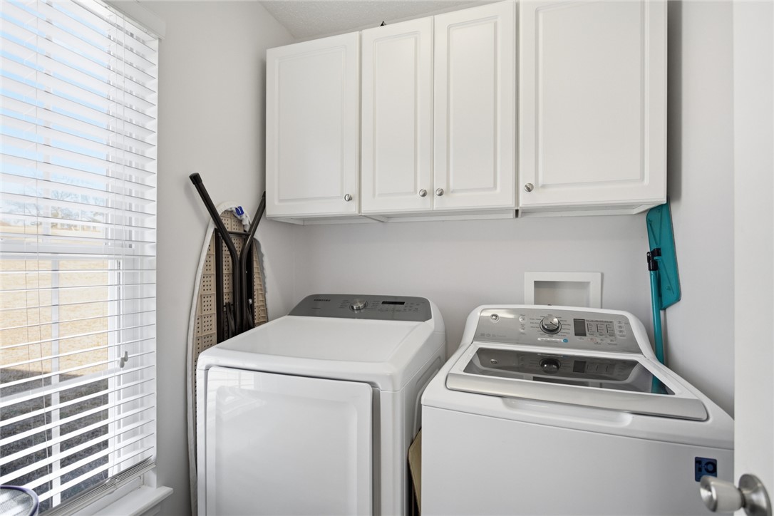 158 State Rd S-37-175 Seneca, SC 29672 - Photo 14 of 43 Functional laundry room featuring overhead cabinetry for organized storage.