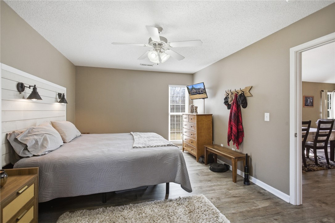 158 State Rd S-37-175 Seneca, SC 29672 - Photo 17 of 43 This inviting bedroom features plank flooring and abundant natural light.