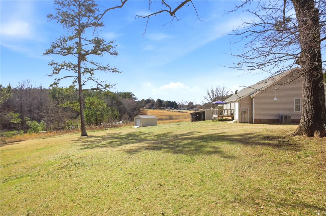 158 State Rd S-37-175 Seneca, SC 29672 - Photo 2 of 43 This expansive yard offers serene outdoor living with ample space for relaxation and activities.