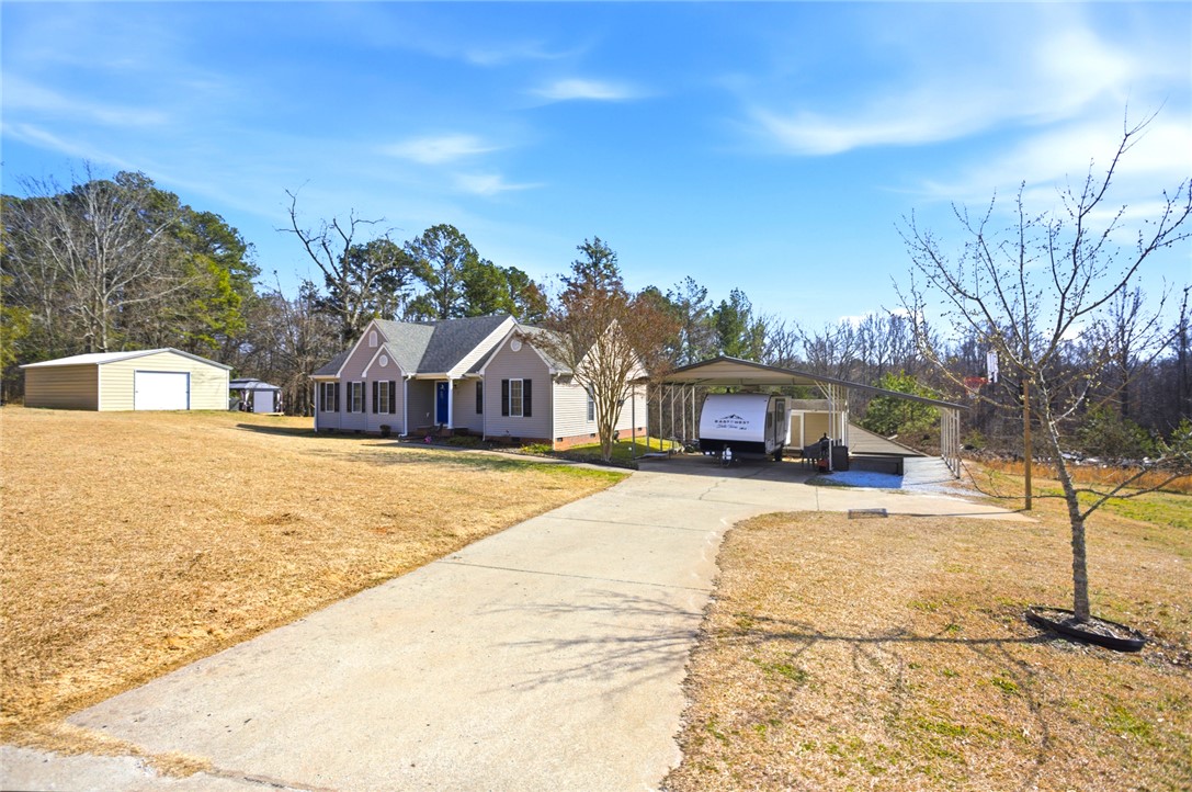158 State Rd S-37-175 Seneca, SC 29672 - Photo 3 of 43 This charming residence offers ample outdoor space and practical structures for diverse needs.