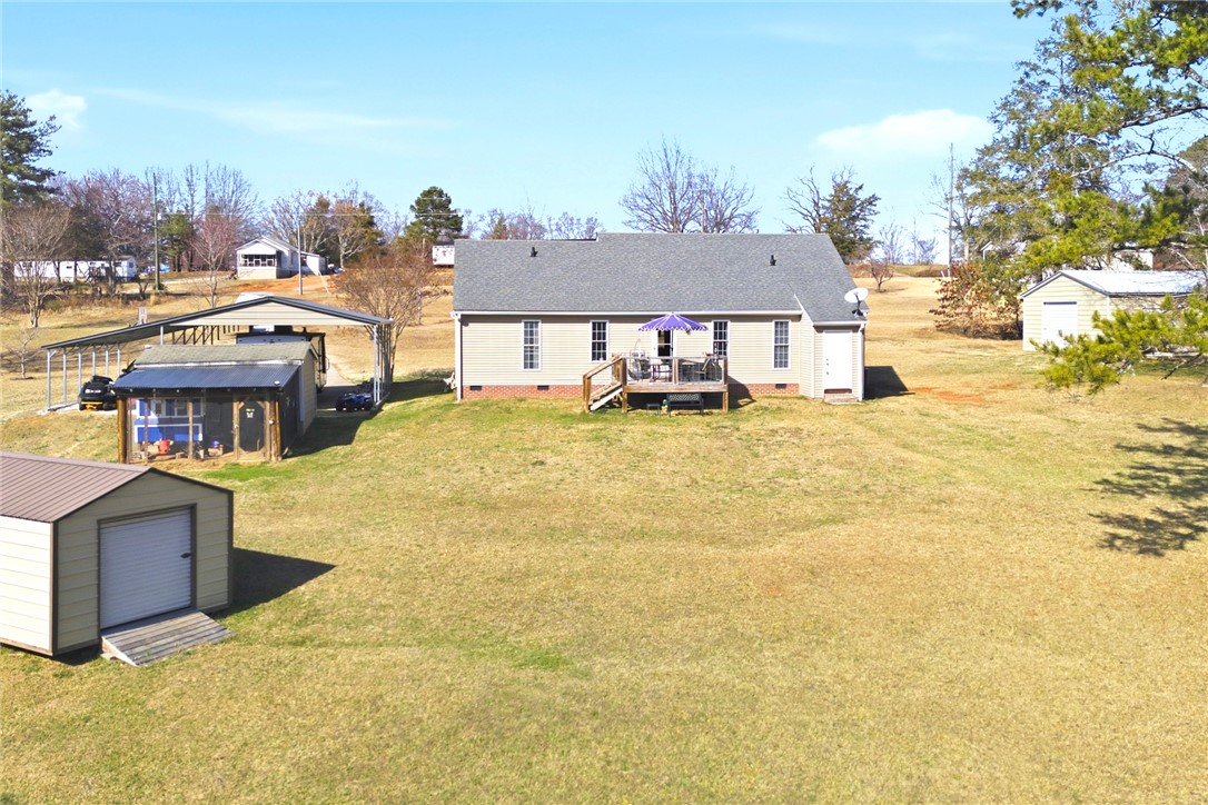 158 State Rd S-37-175 Seneca, SC 29672 - Photo 41 of 43 Expansive outdoor living with a spacious deck and ample green space for enjoyment.