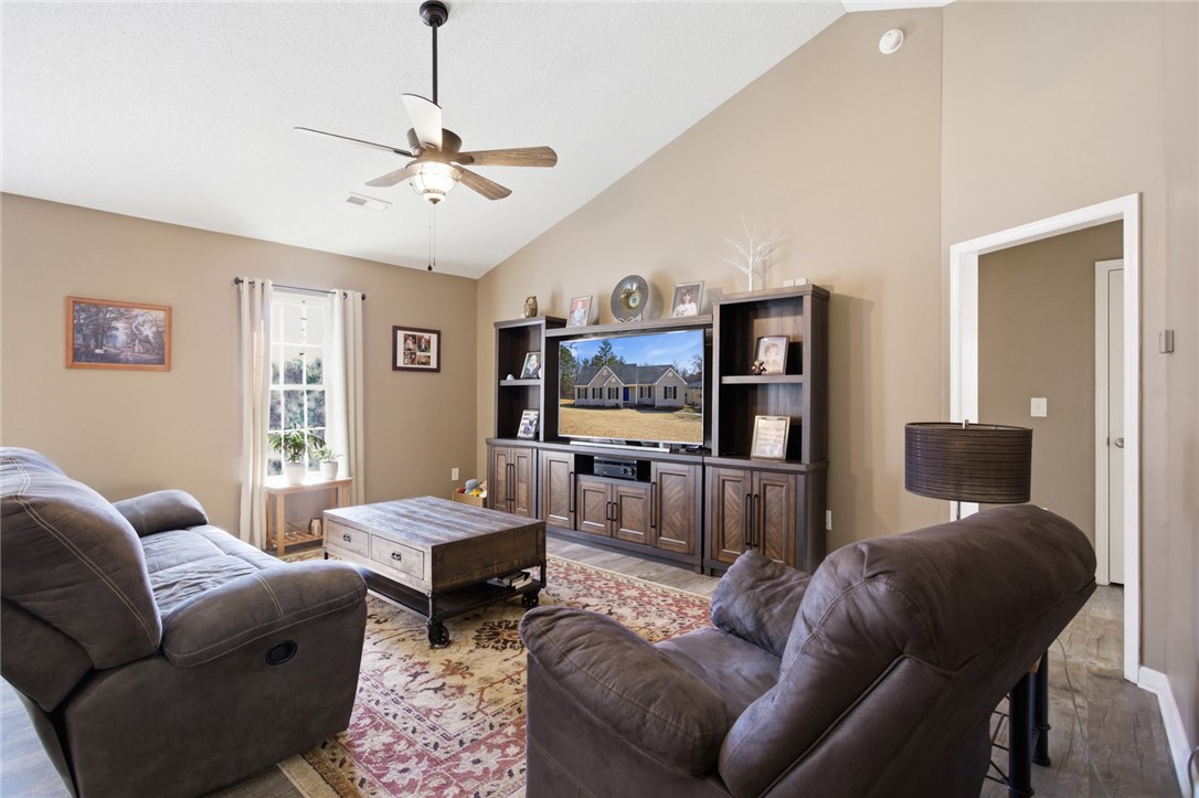 158 State Rd S-37-175 Seneca, SC 29672 - Photo 6 of 43 This living area features a high vaulted ceiling, creating an open and airy atmosphere for everyday living.