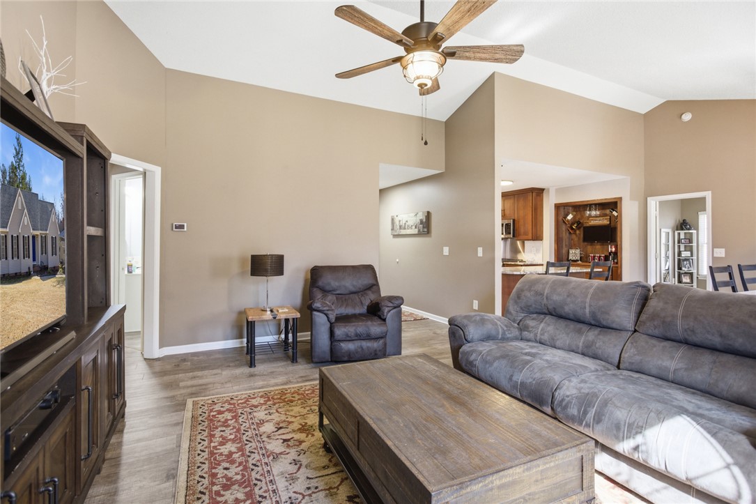 158 State Rd S-37-175 Seneca, SC 29672 - Photo 7 of 43 This living room features vaulted ceilings and an open concept layout, flowing into the adjacent kitchen.