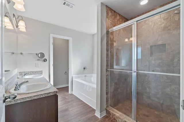 a bathroom with a granite countertop sink toilet and shower