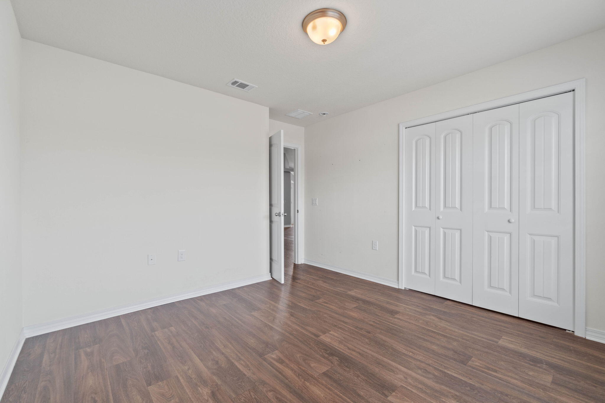 229 Croft Circle Crestview, FL 32536 - Photo 16 of 22 a view of an empty room with wooden floor