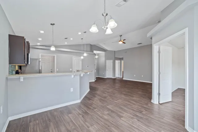 a view of a kitchen with a sink and wooden floor
