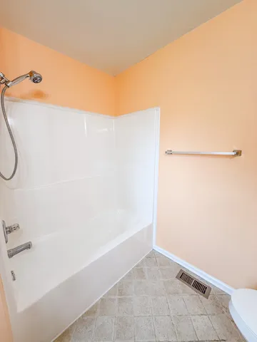 a bathroom with a shower and a bathtub