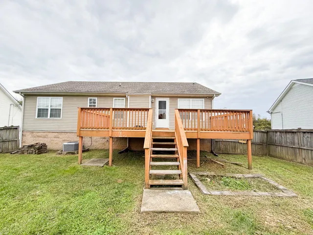 a view of a house with backyard and a chair