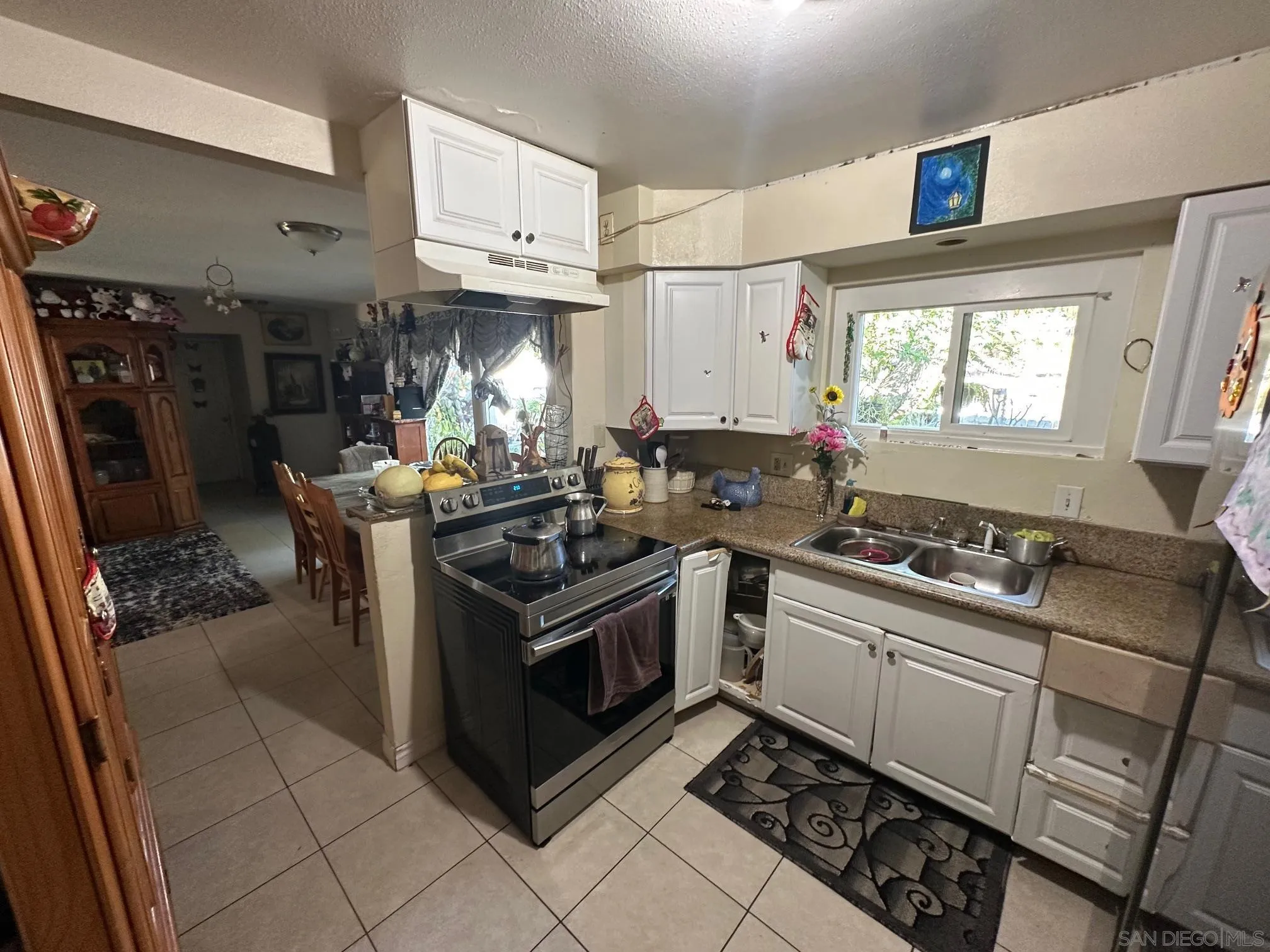 223 South Stage Coach Lane Fallbrook, CA 92028 - Photo 13 of 20 a kitchen with stainless steel appliances a stove a sink and a refrigerator