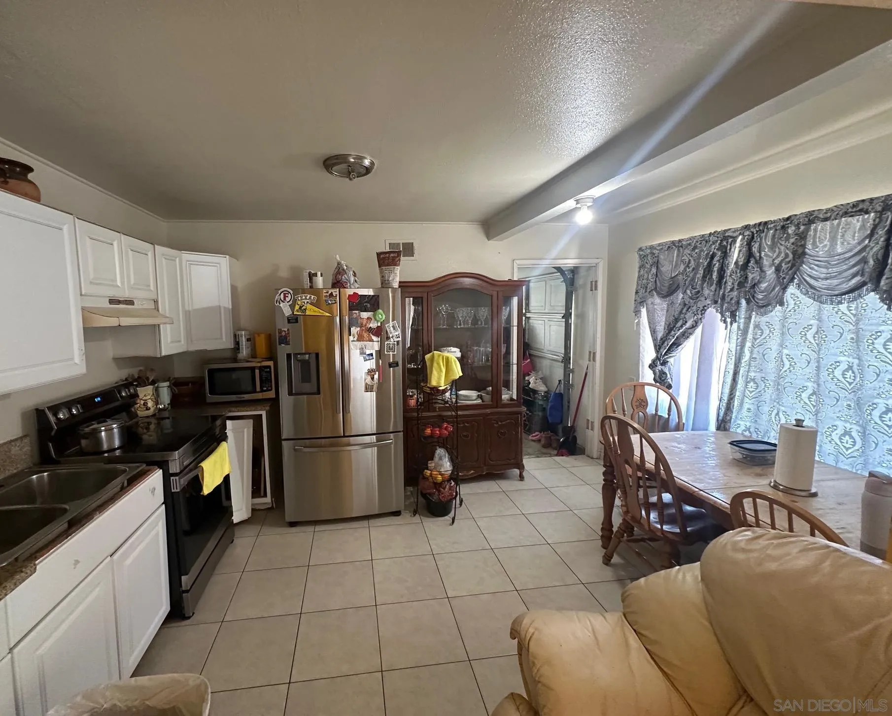 223 South Stage Coach Lane Fallbrook, CA 92028 - Photo 16 of 20 a kitchen with a refrigerator and a sink