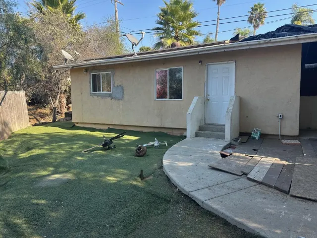 a backyard of a house with table and chairs