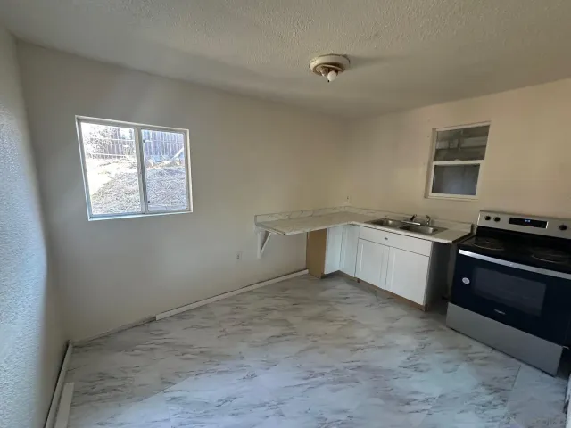 a kitchen with a stove and a refrigerator