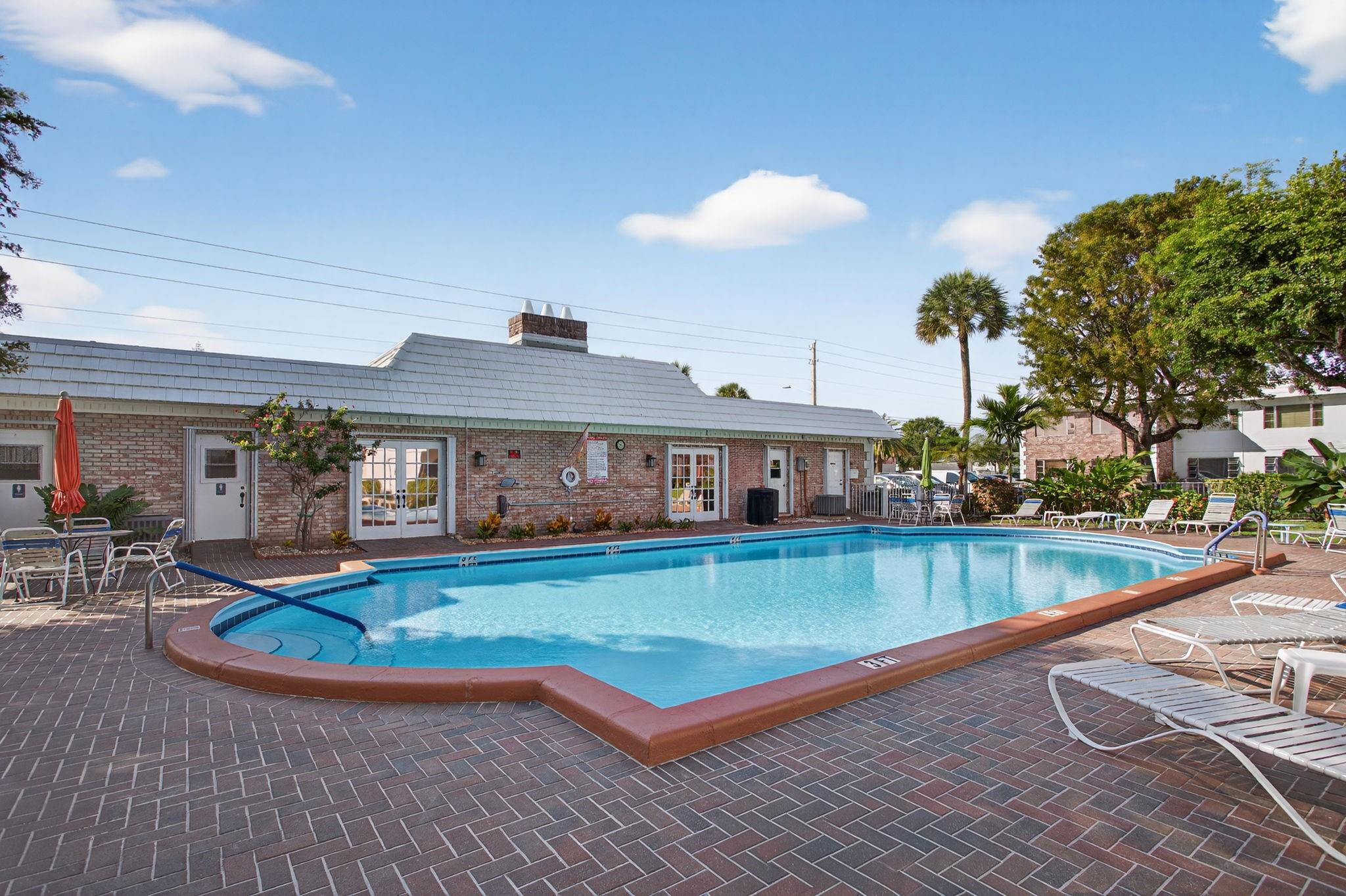 418 South Cypress Road, Unit 110 Pompano Beach, FL 33060 - Photo 21 of 28 a view of a swimming pool with seating space