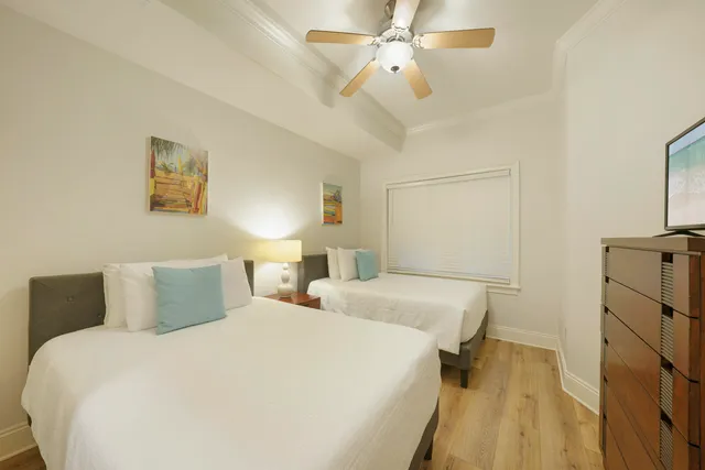 a bedroom with a bed and a lamp on desk