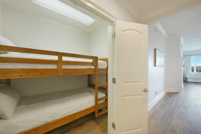 a view of a balcony with chairs and wooden fence