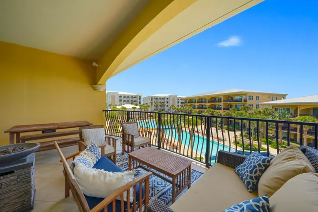 a view of a balcony with wooden floor and outdoor seating