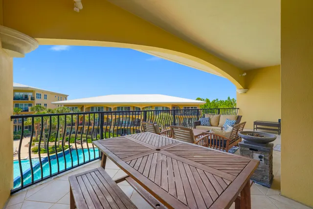 a view of a balcony with a floor to ceiling window and wooden fence