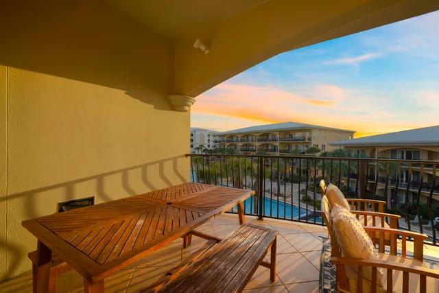 a view of a house with swimming pool and sitting area