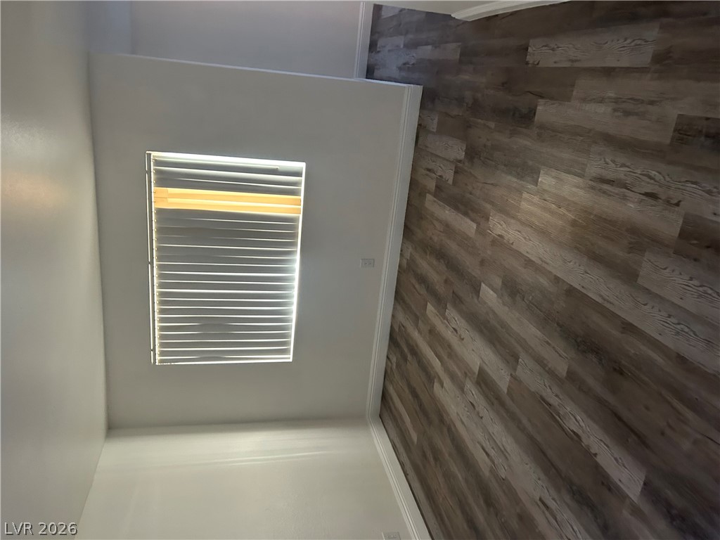 1852 North Decatur Boulevard, Unit 103 Las Vegas, NV 89108 - Photo 7 of 10 Natural light illuminates rich hardwood flooring throughout this versatile living space.