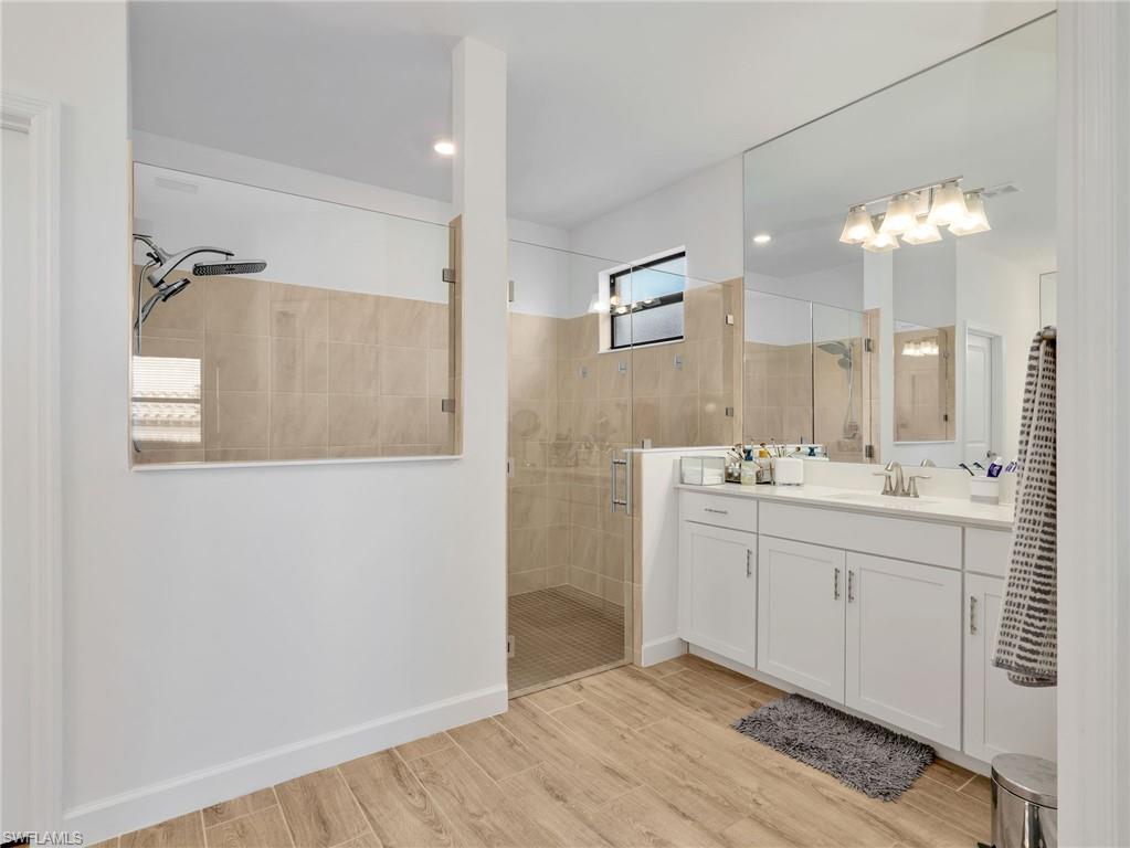 18278 Ridgeline Drive Estero, FL 33928 - Photo 19 of 45 a bathroom with a double vanity sink mirror and shower