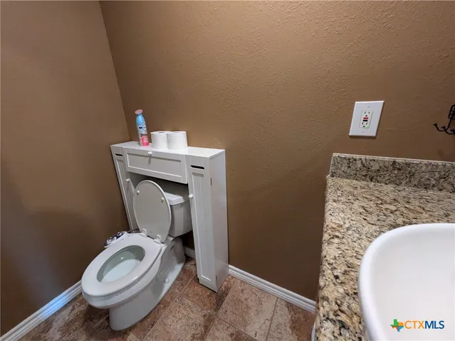 a bathroom with a toilet and a sink