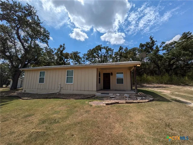 a view of house with yard