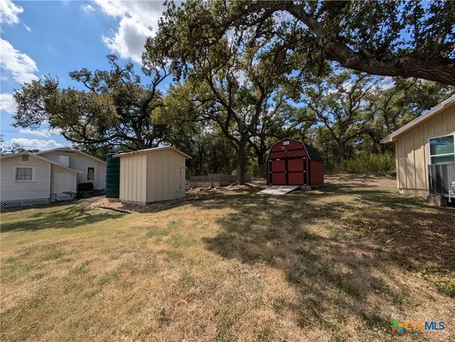 a view of a yard with a tree