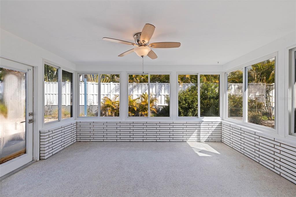 176 175th Avenue East Redington Shores, FL 33708 - Photo 12 of 37 a view of an empty room and window