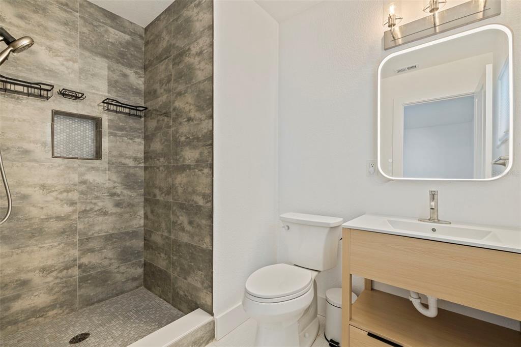176 175th Avenue East Redington Shores, FL 33708 - Photo 18 of 37 a bathroom with a sink a toilet and shower