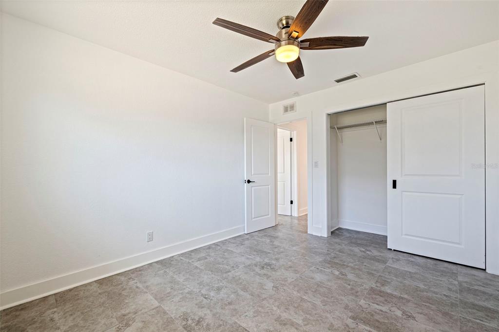 176 175th Avenue East Redington Shores, FL 33708 - Photo 20 of 37 an empty room with closet and a ceiling fan