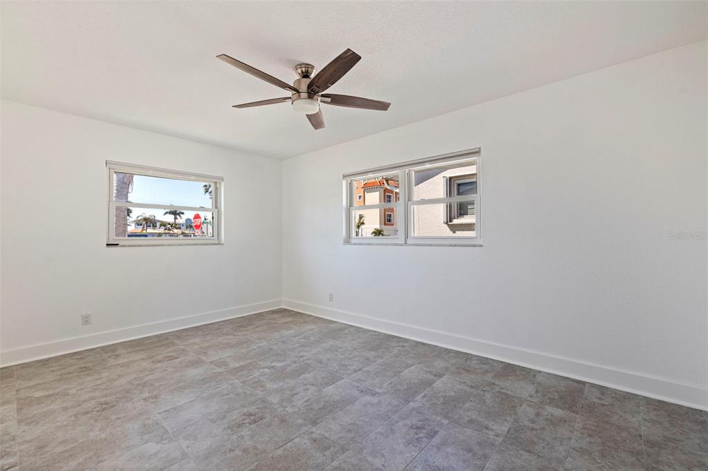 176 175th Avenue East Redington Shores, FL 33708 - Photo 22 of 37 a view of a big room with wooden floor and windows