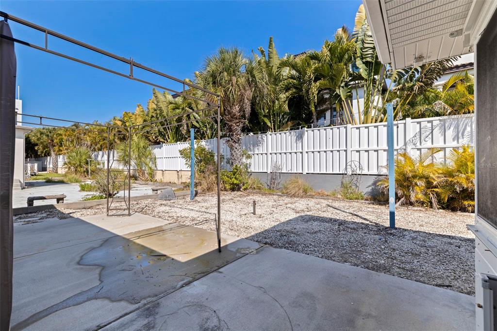 176 175th Avenue East Redington Shores, FL 33708 - Photo 24 of 37 a view of a backyard and a house