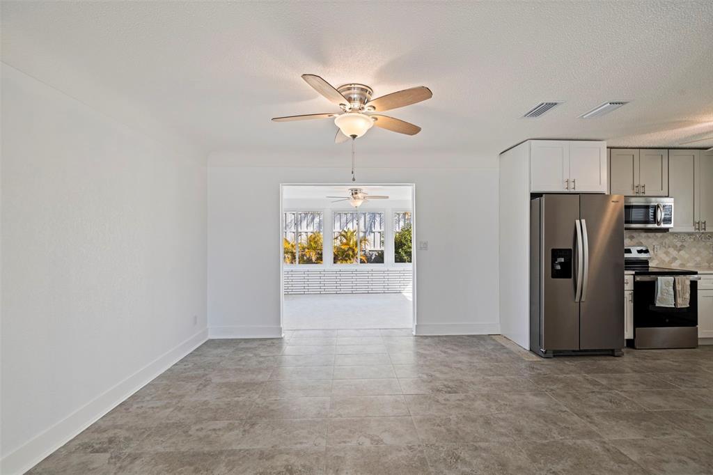 176 175th Avenue East Redington Shores, FL 33708 - Photo 7 of 37 a view of an empty room with a ceiling fan