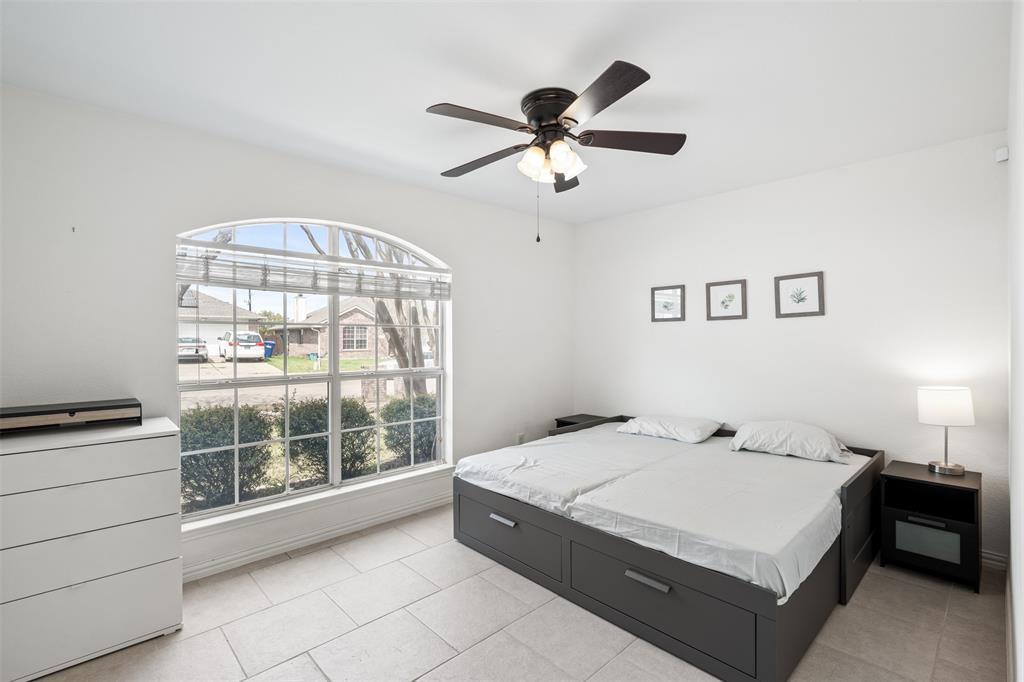 1011 Ridgecrest Drive McKinney, TX 75069 - Photo 25 of 31 Arched window with gridded panes, ceiling fan with integrated lighting, recessed lighting, tile flooring, and white walls
