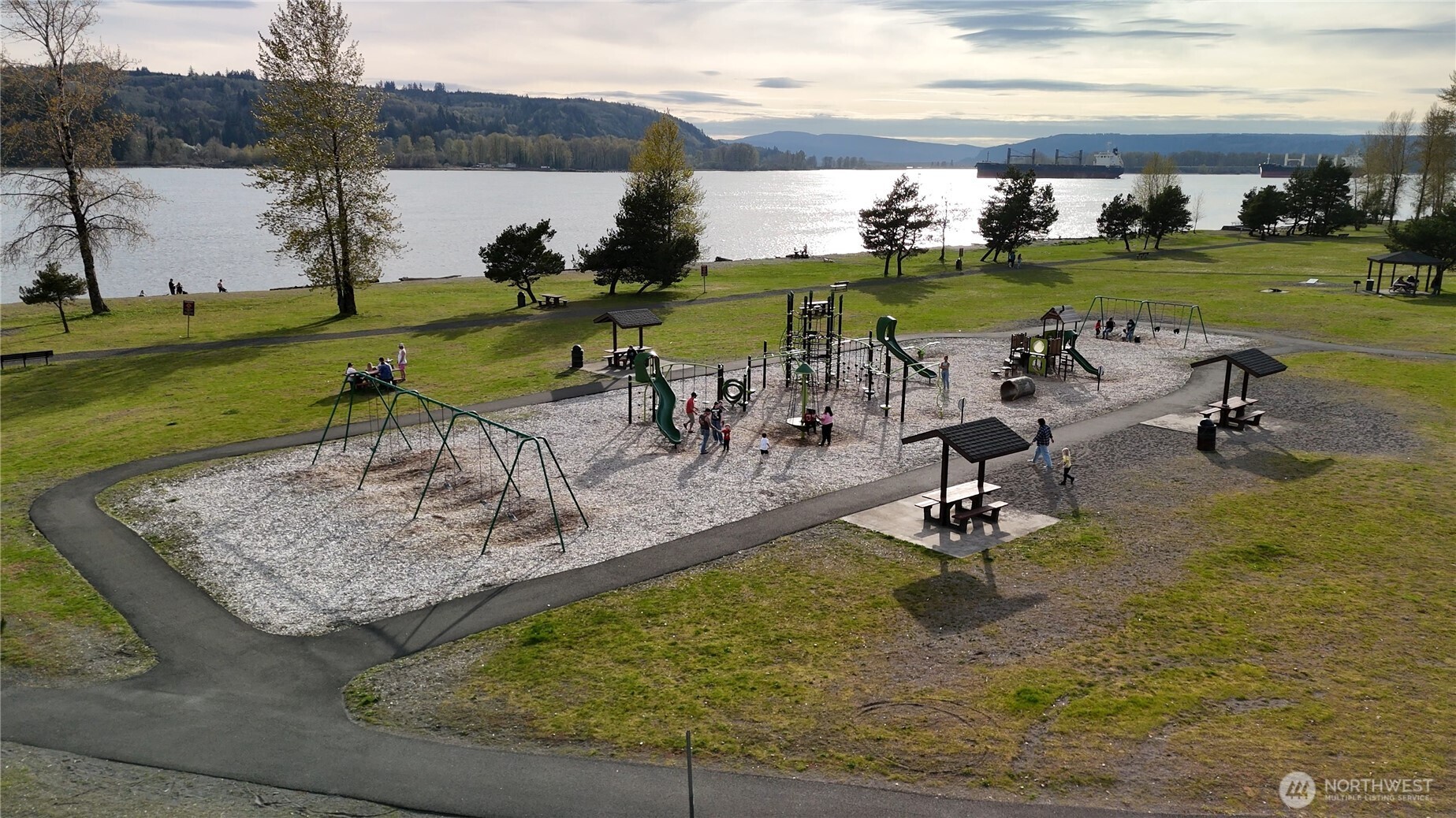 151 Barlow Point Road Longview, WA 98632 - Photo 25 of 34 a view of a lake with a yard and outdoor seating
