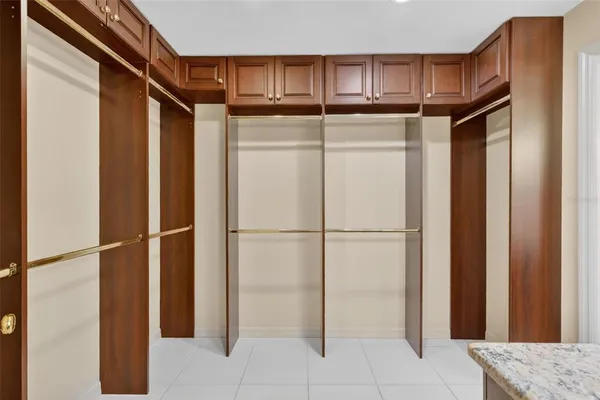 a view of an empty room with a cabinet and a window