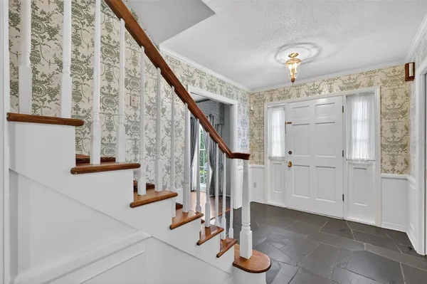 a view of entryway and hall with wooden floor