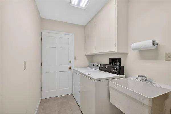 an aerial view of a residential houses with outdoor space and lake view