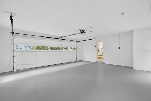 an aerial view of residential houses with outdoor space and lake view