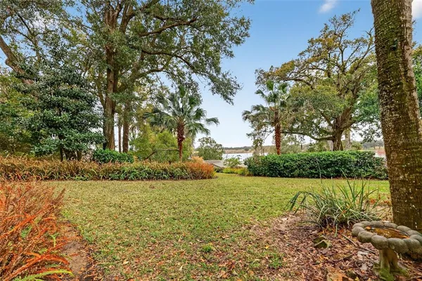 an aerial view of ocean and residential houses with outdoor space