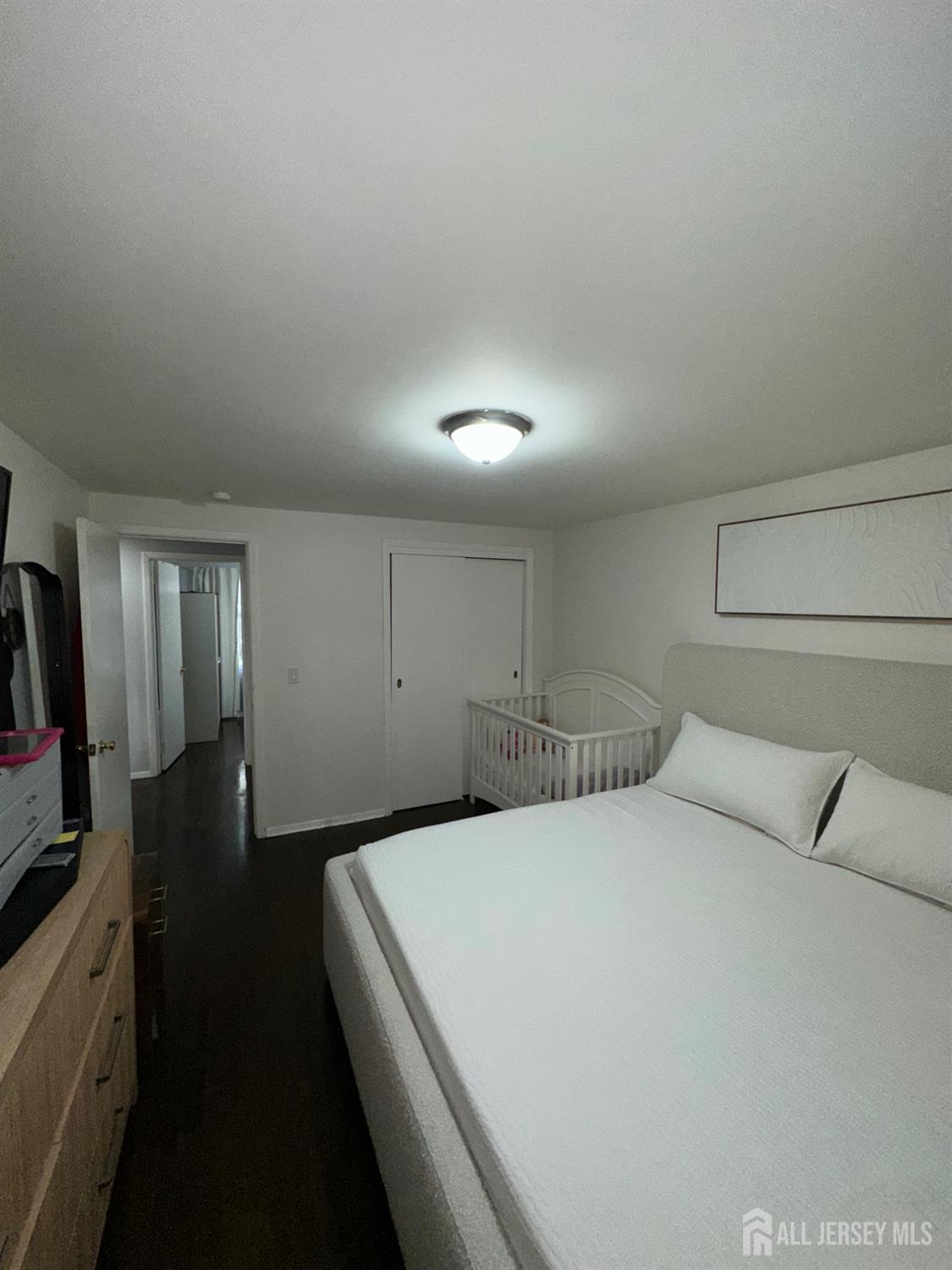 1019 Main Street Fords, NJ 08863 - Photo 11 of 20 a bedroom with a bed and a flat screen tv