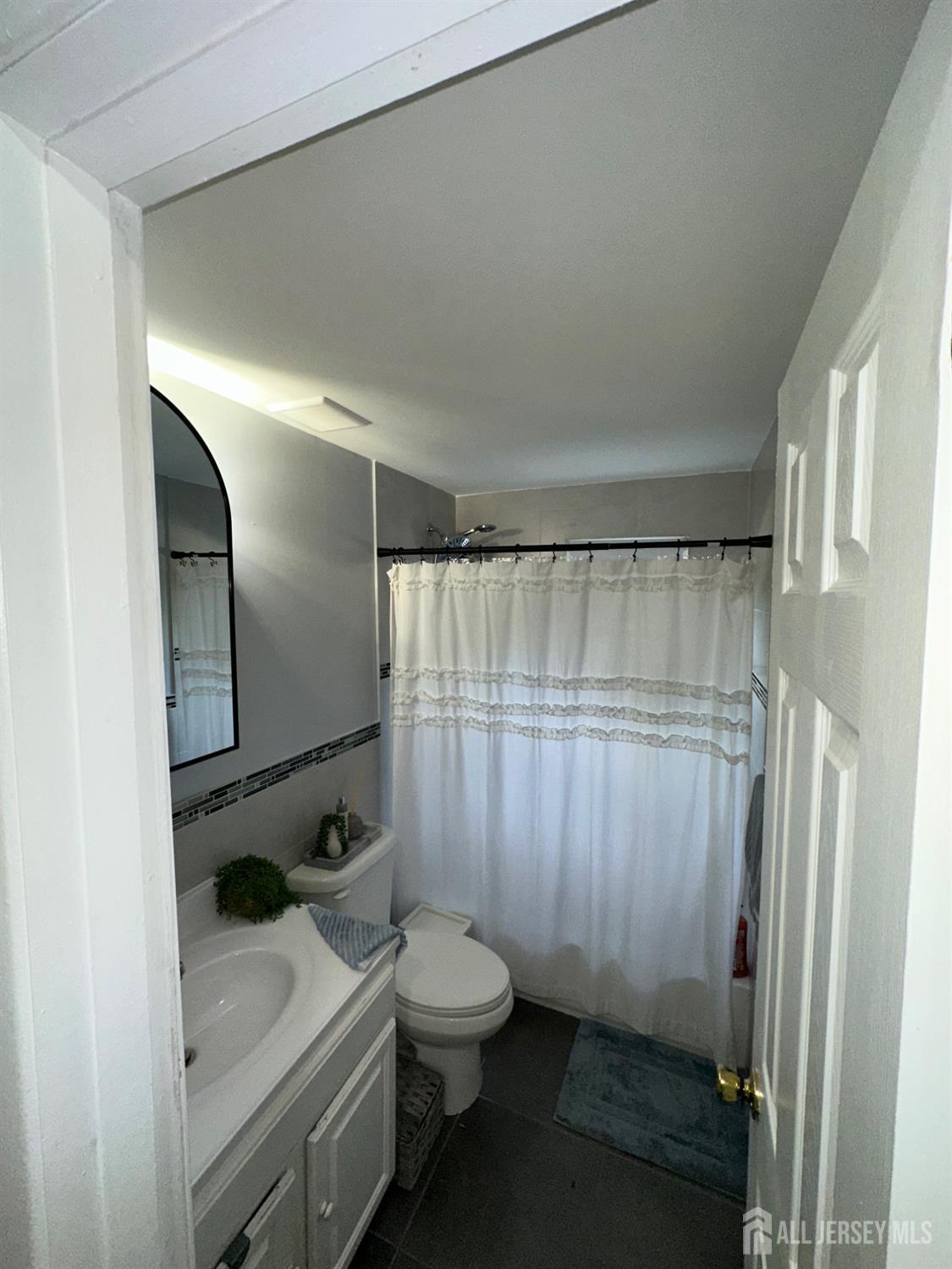1019 Main Street Fords, NJ 08863 - Photo 12 of 20 a bathroom with a granite countertop sink toilet and shower